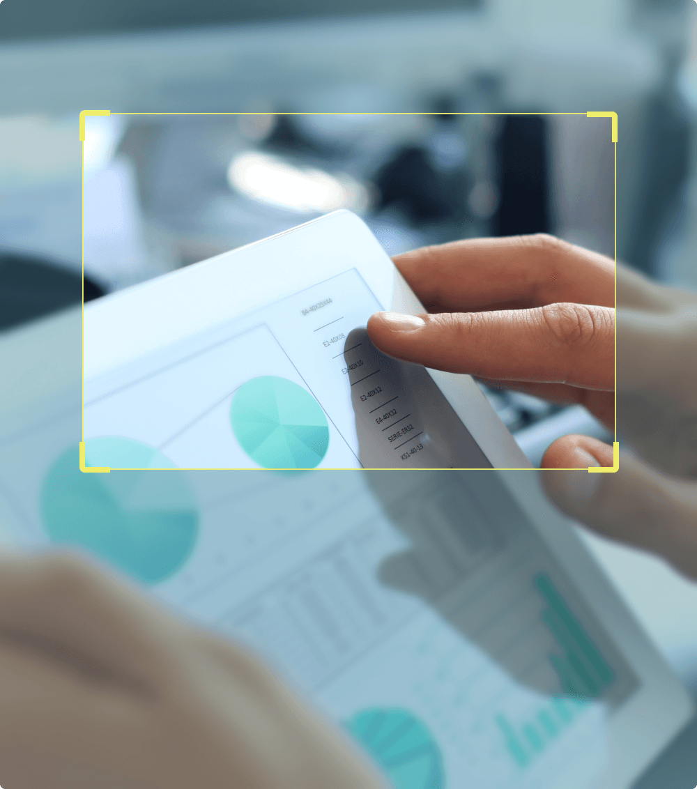 Tablet displaying analytical charts and graphs, with a yellow focus frame highlighting the top portion